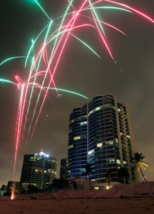 A long exposure photo of fireworks over the beach