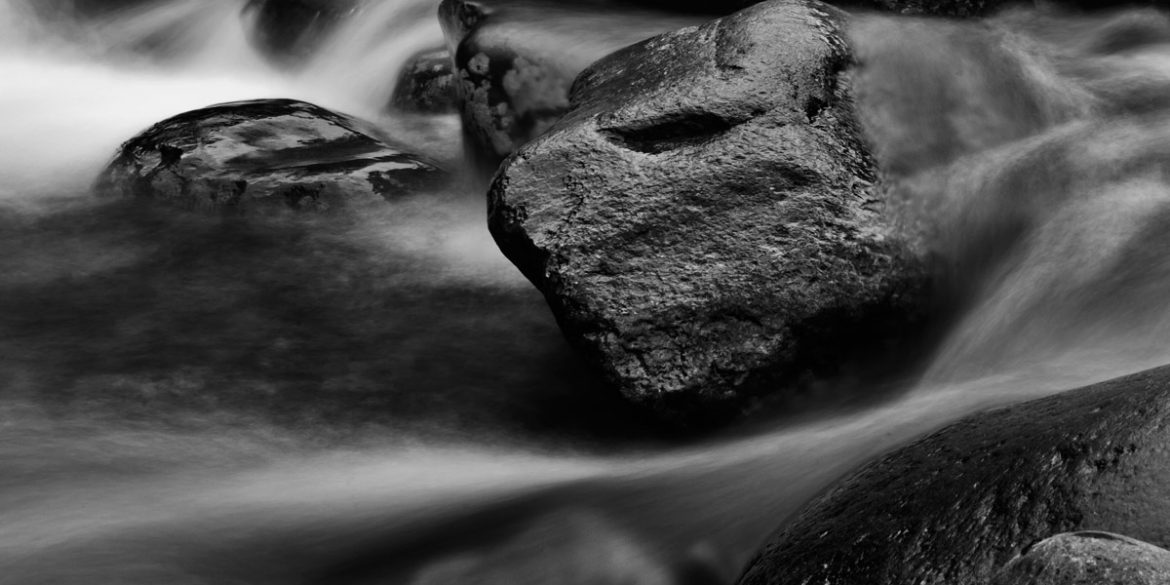 A long exposure photography shot of rocks in a river in Great Smoky Mountains National Park