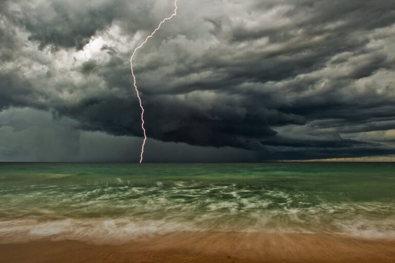 A long exposure photo taken during the day of lightning over the ocean